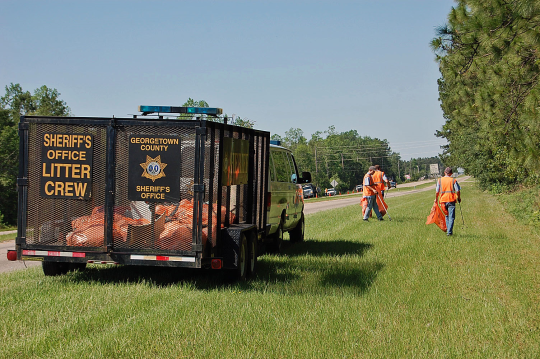 Inmates picking up litter on the highway